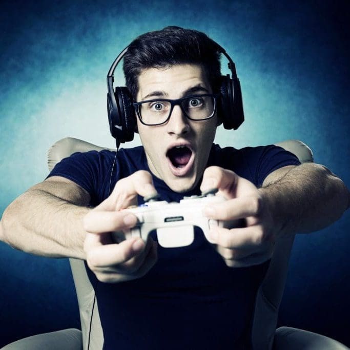 EUGameHost videogame addicted young guy playing with console .