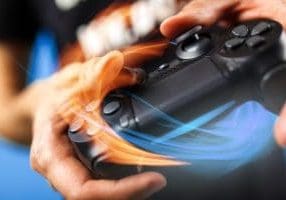 Gaming DDoS Attacks Male hands holding a gaming console controller