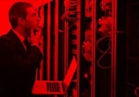 UK GDPR Compliance young engeneer business man with thin modern aluminium laptop in network server room