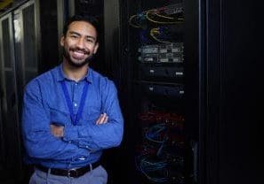 Server Security Server room, portrait or happy male developer for online cybersecurity glitch or machine system. IT support, smile or proud engineer fixing network for information technology solution in data center.