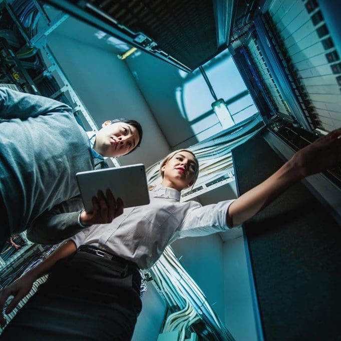 Young engineers businessmen in network server room